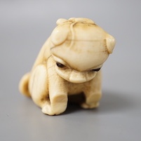 A 19th century Japanese carved ivory ‘dog’ netsuke 3cm tall